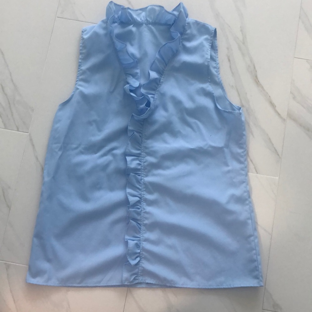 Light blue ruffle top. Poly/Cotton blend.